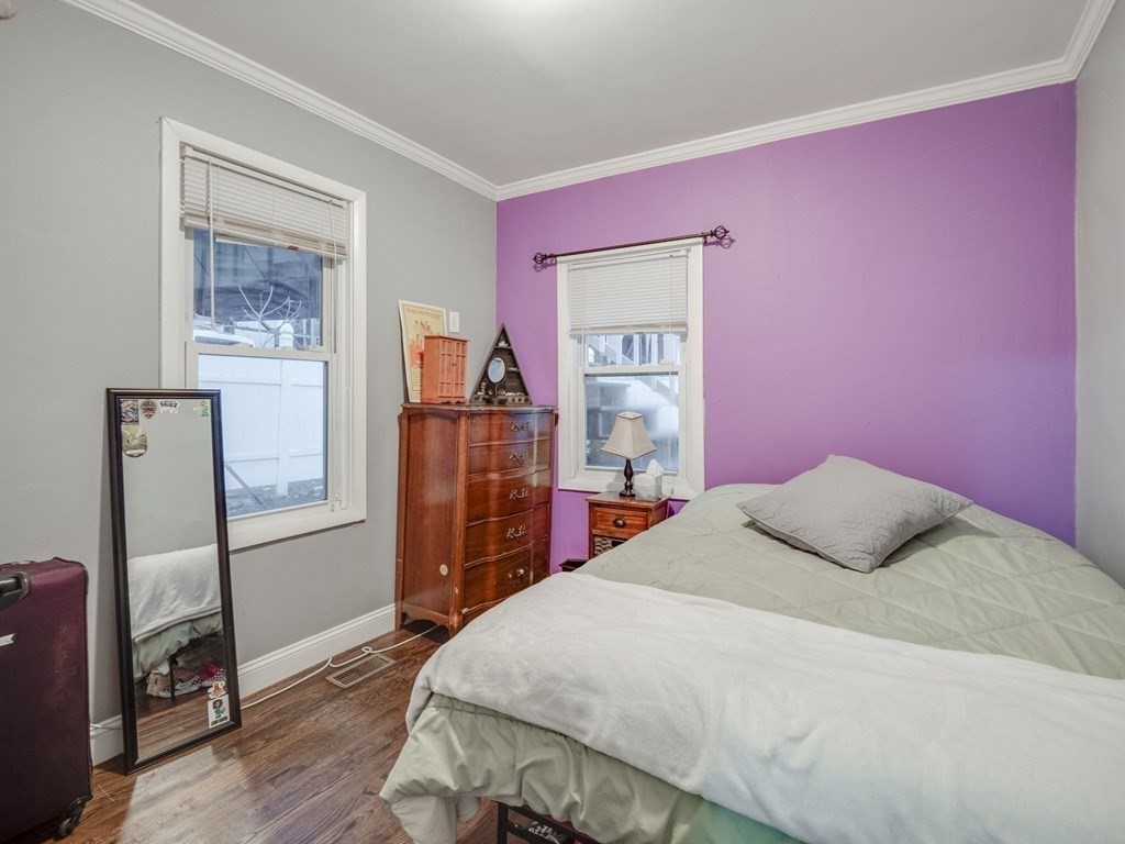48 Chestnut Street Chelsea, MA 02150 - Photo 18 of 42 a bedroom with a bed and a dresser