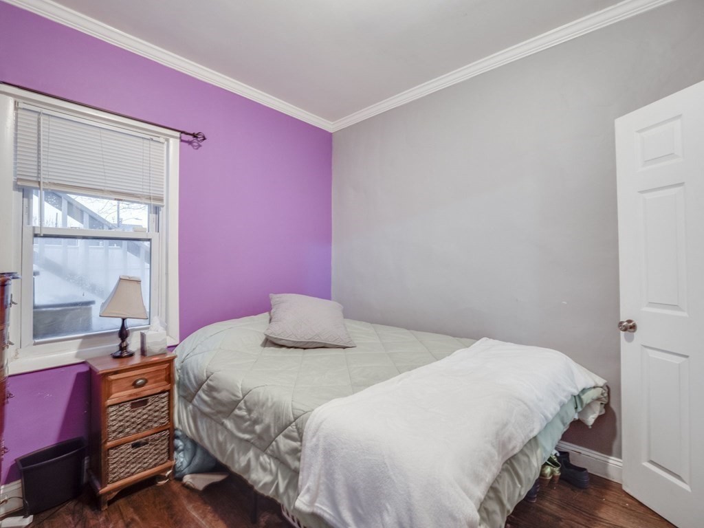 48 Chestnut Street Chelsea, MA 02150 - Photo 19 of 42 a bedroom with a bed and a window