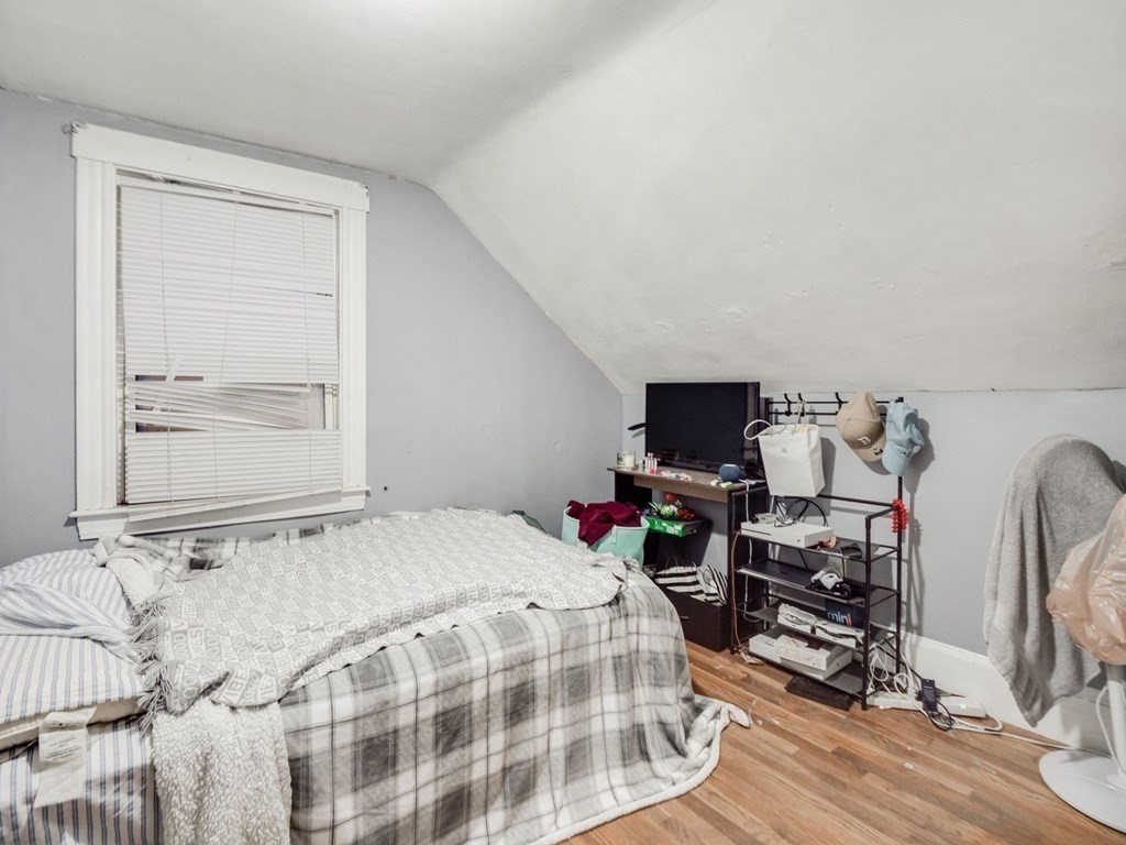 48 Chestnut Street Chelsea, MA 02150 - Photo 22 of 42 a bedroom with a bed and wooden floor