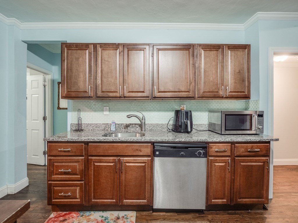 48 Chestnut Street Chelsea, MA 02150 - Photo 3 of 42 a kitchen with granite countertop cabinets and window