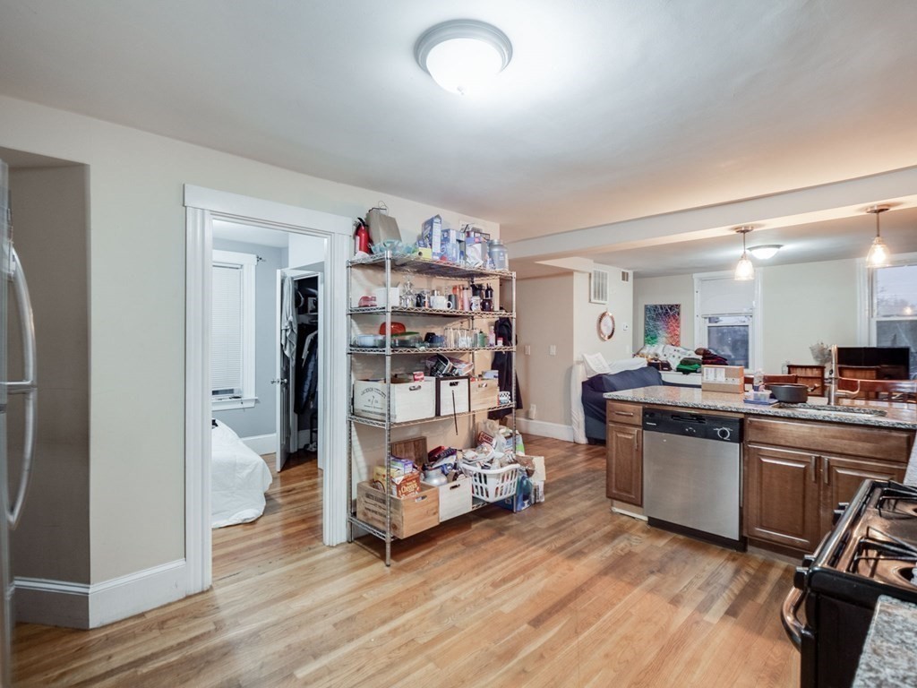 48 Chestnut Street Chelsea, MA 02150 - Photo 10 of 42 a kitchen with stainless steel appliances wooden floor and sink