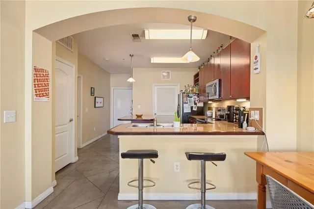 a kitchen with kitchen island cabinets and refrigerator