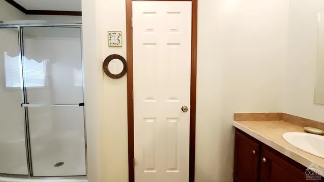 a bathroom with a shower and mirror