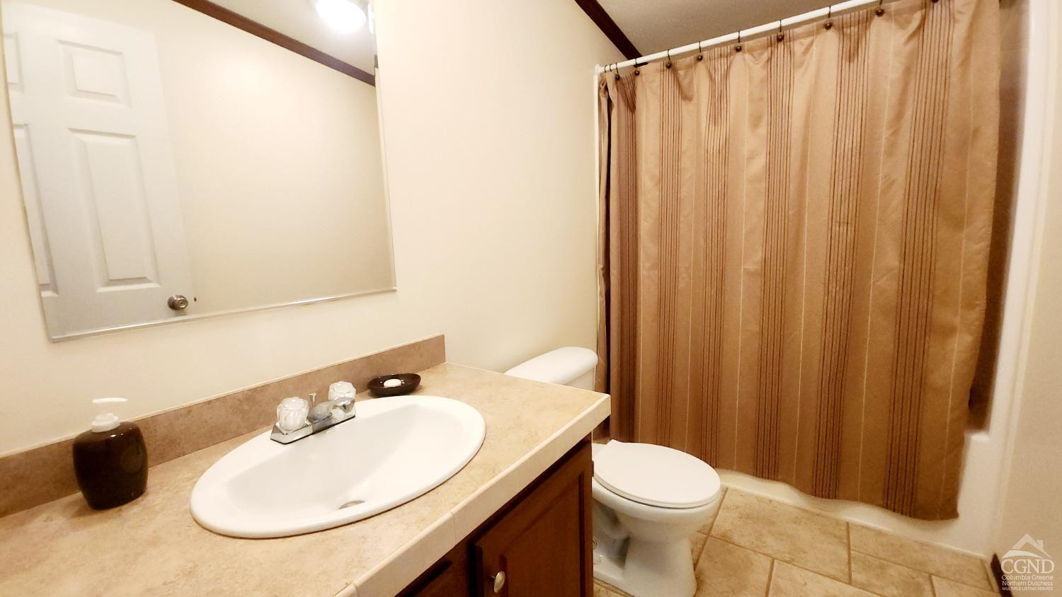 76 Gibson Road Durham, NY 12083 - Photo 16 of 22 a bathroom with a sink and a mirror