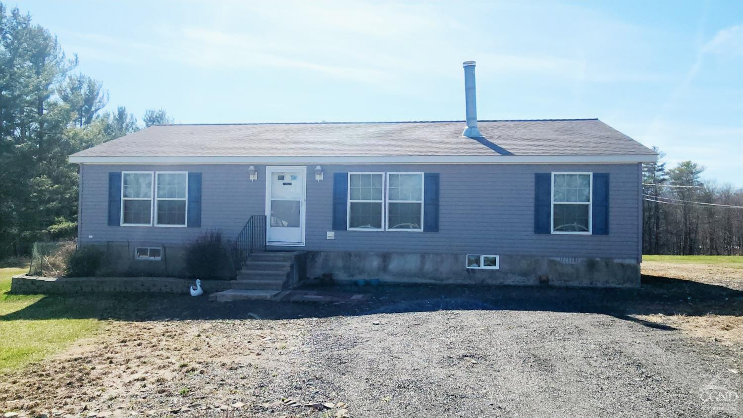 76 Gibson Road Durham, NY 12083 - Photo 20 of 22 a front view of a house with a yard