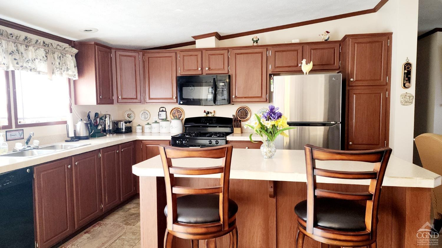 76 Gibson Road Durham, NY 12083 - Photo 6 of 22 a kitchen with stainless steel appliances a stove a sink refrigerator and microwave