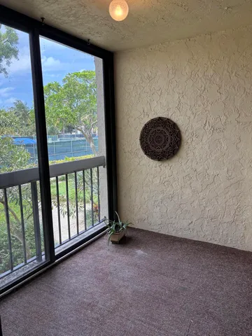 a view of an empty room with a floor to ceiling window