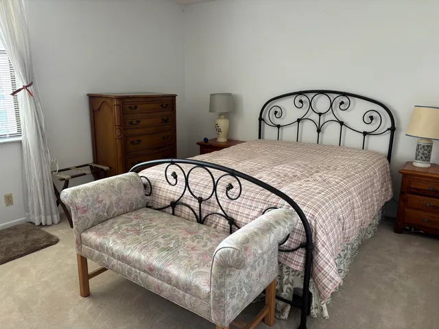 a bedroom with a bed and a dresser