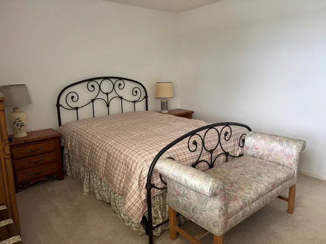 a bedroom with a bed and a dresser