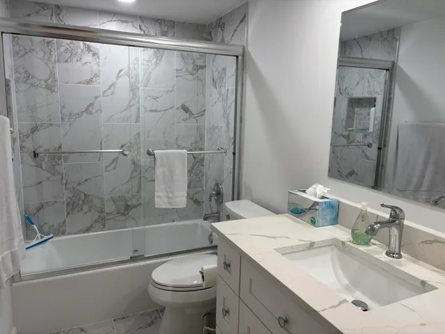 a bathroom with a sink toilet and shower