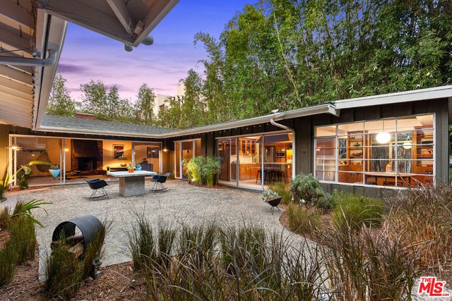 a view of a house with backyard stove and sitting area