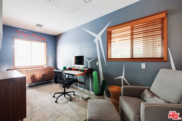 a work room with furniture and windows