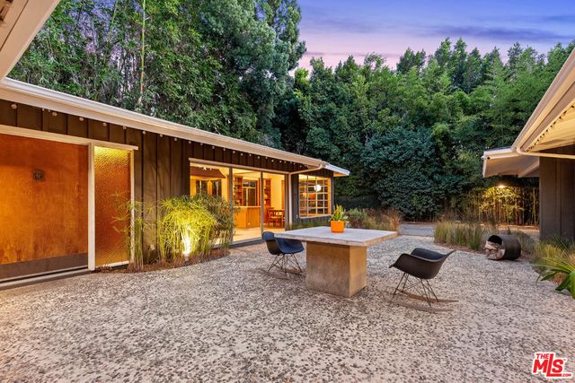 a view of a patio with chairs and plants
