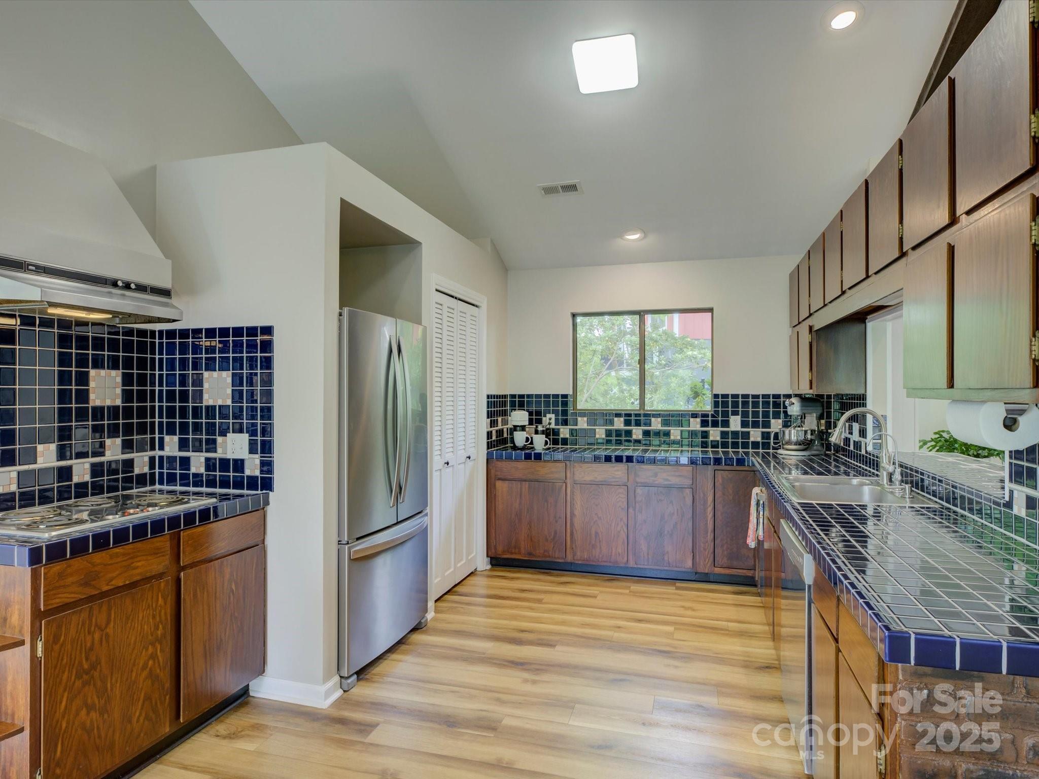 1114 Palmyra Drive Tega Cay, SC 29708 - Photo 13 of 48 a kitchen with stainless steel appliances granite countertop a refrigerator a stove and a sink