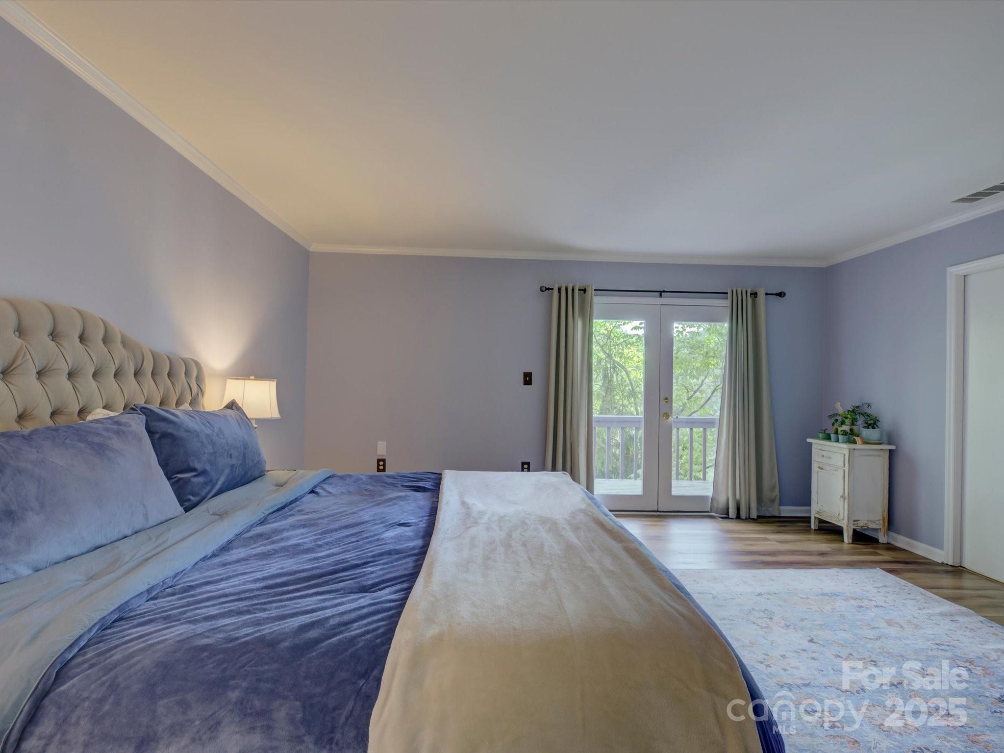 1114 Palmyra Drive Tega Cay, SC 29708 - Photo 19 of 48 a bedroom with a large bed and large windows