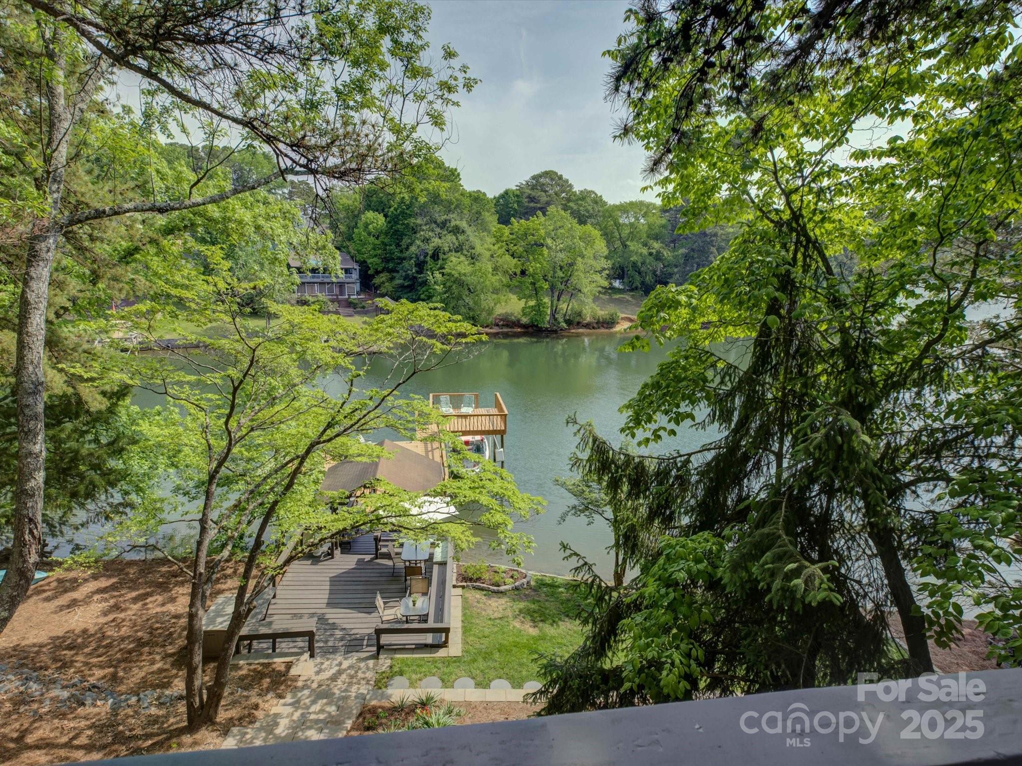1114 Palmyra Drive Tega Cay, SC 29708 - Photo 23 of 48 a view of a garden with a bench