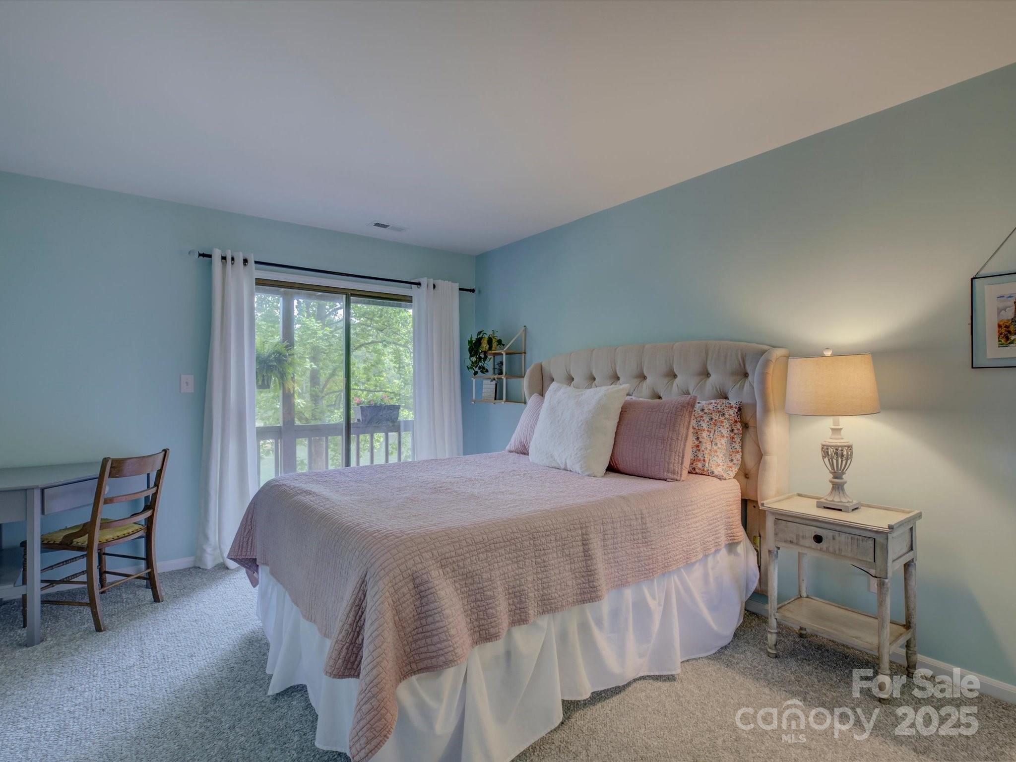 1114 Palmyra Drive Tega Cay, SC 29708 - Photo 27 of 48 a bedroom with a bed a table and chair