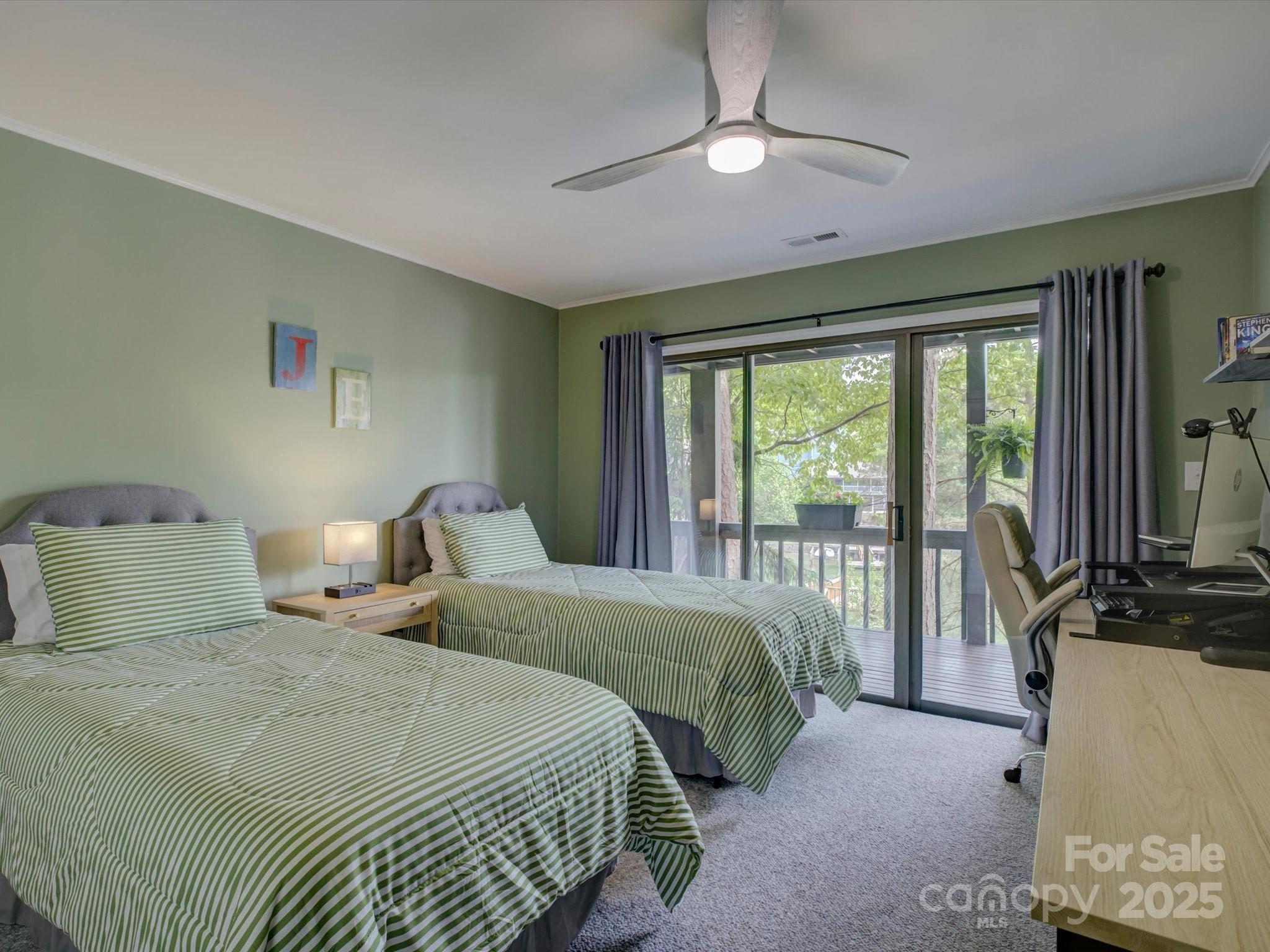 1114 Palmyra Drive Tega Cay, SC 29708 - Photo 29 of 48 a bedroom with a balcony a bed and a chandelier