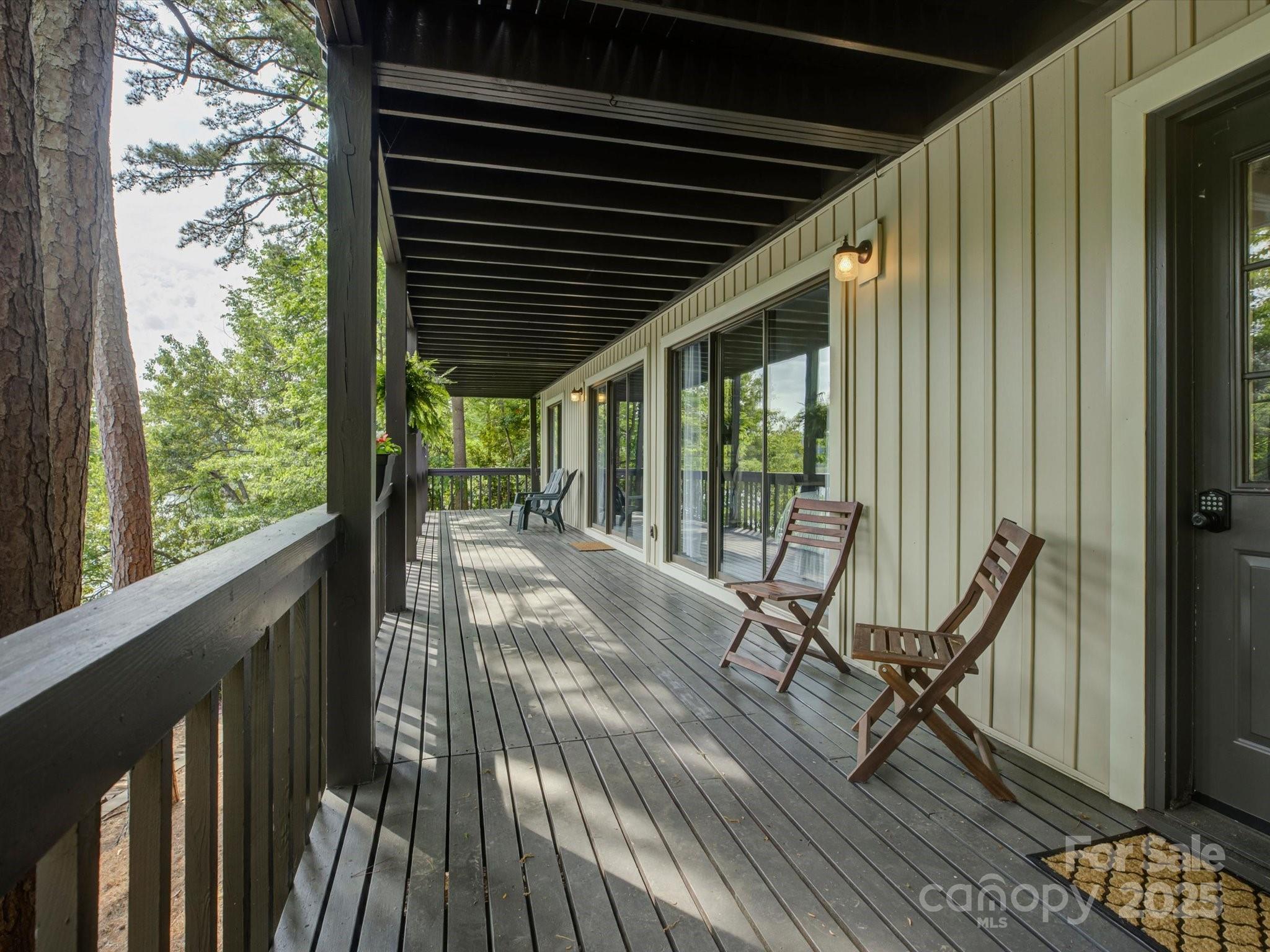 1114 Palmyra Drive Tega Cay, SC 29708 - Photo 32 of 48 a view of a balcony with chairs and wooden floor