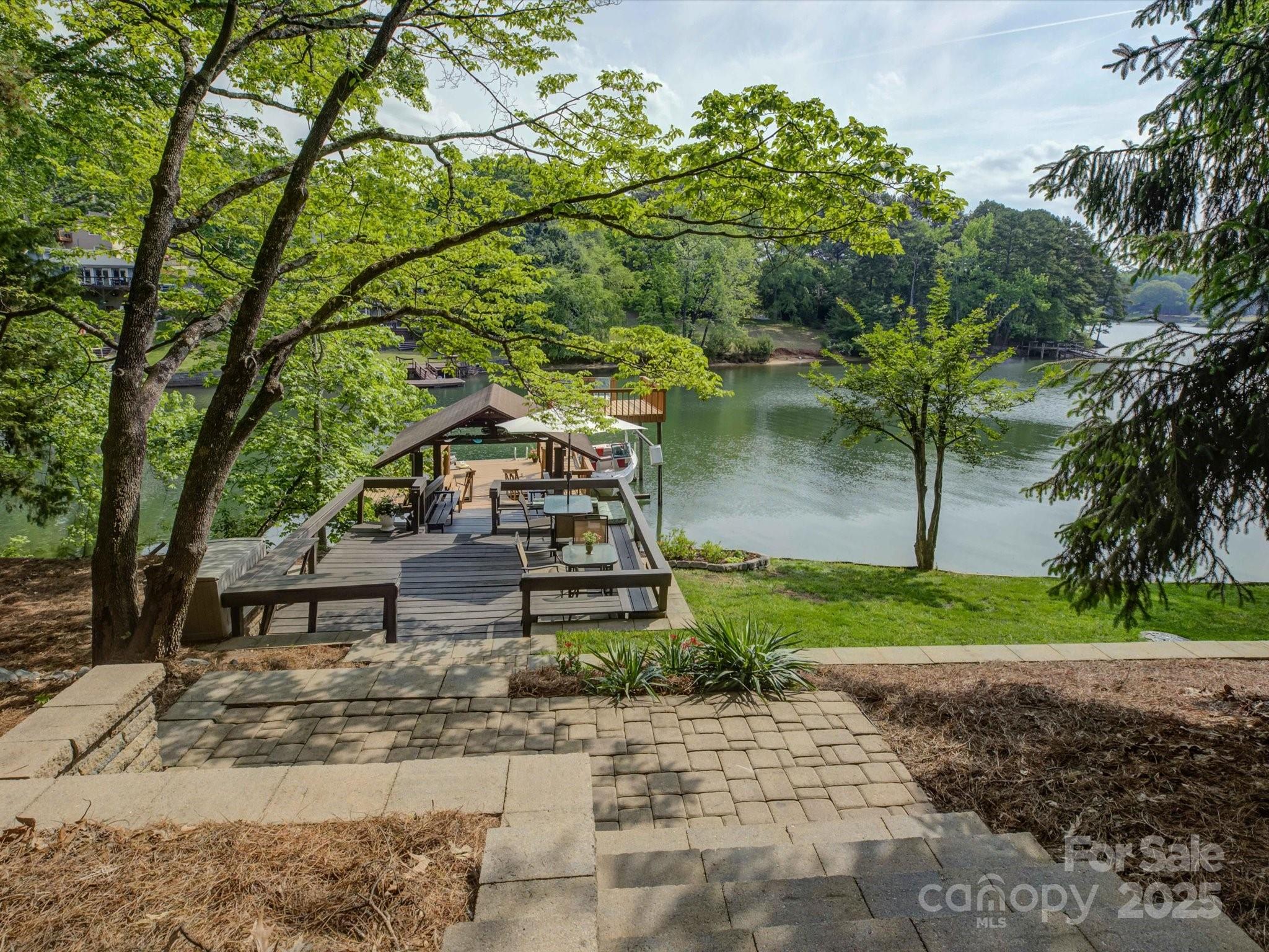 1114 Palmyra Drive Tega Cay, SC 29708 - Photo 34 of 48 a wooden bench sitting in the middle of a yard