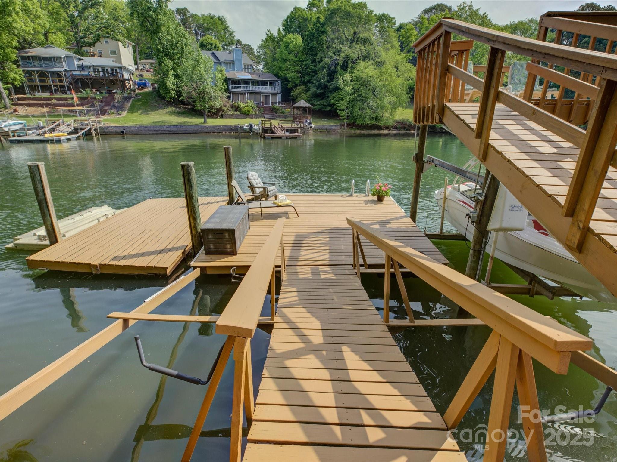 1114 Palmyra Drive Tega Cay, SC 29708 - Photo 42 of 48 a view of a balcony with two chairs and wooden floor
