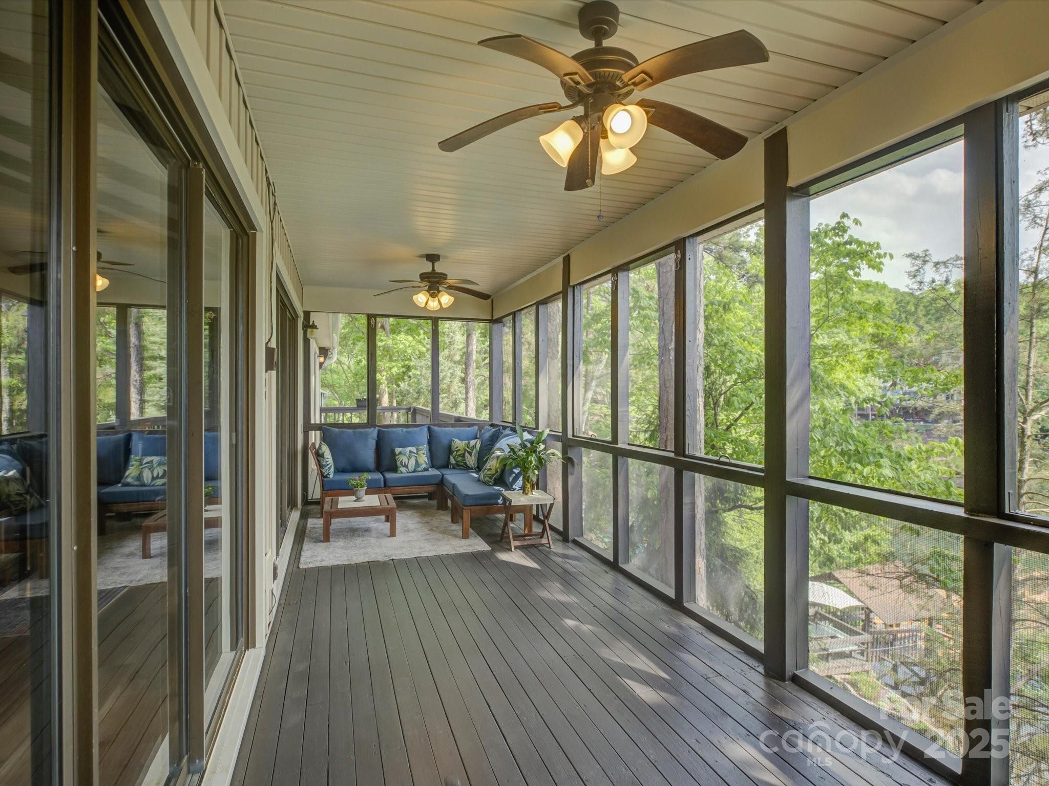 1114 Palmyra Drive Tega Cay, SC 29708 - Photo 10 of 48 a view of a livingroom with furniture wooden floor fan and a large window