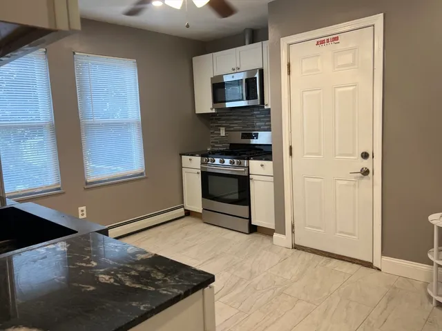 a kitchen with stainless steel appliances granite countertop a stove top oven a sink and a granite counter tops