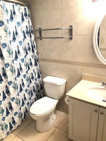 a white toilet sitting next to a bathroom sink