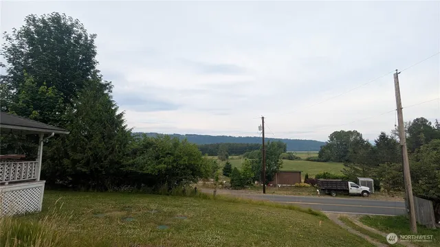 a view of a green field with sitting area
