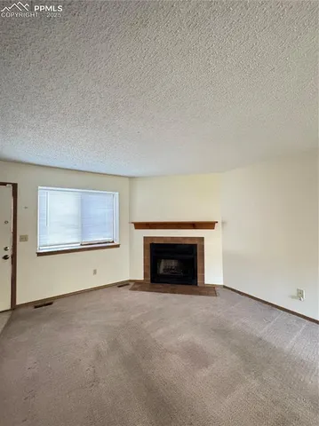 an empty room with furniture and a fireplace
