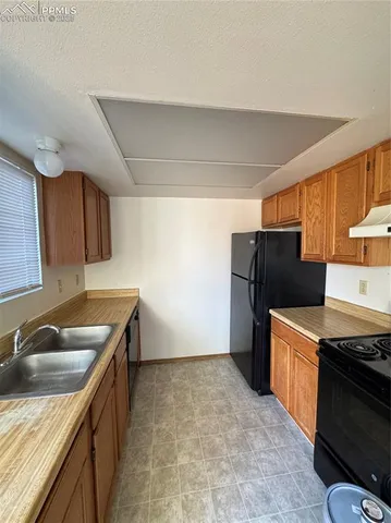 a kitchen that has a sink and a stove