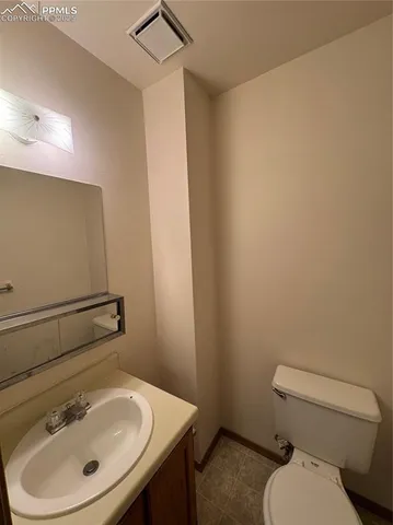 a bathroom with a sink a toilet and mirror