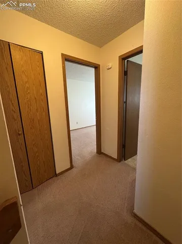 a view of a hallway with closet