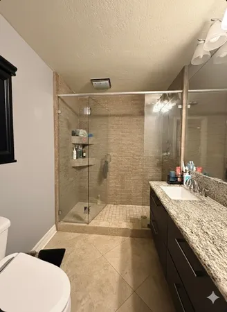 a view of a house with a wooden bench