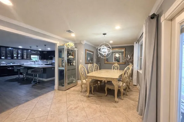 a view of a dining room with furniture and a chandelier