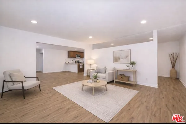 a living room with furniture or couch and a wooden floor