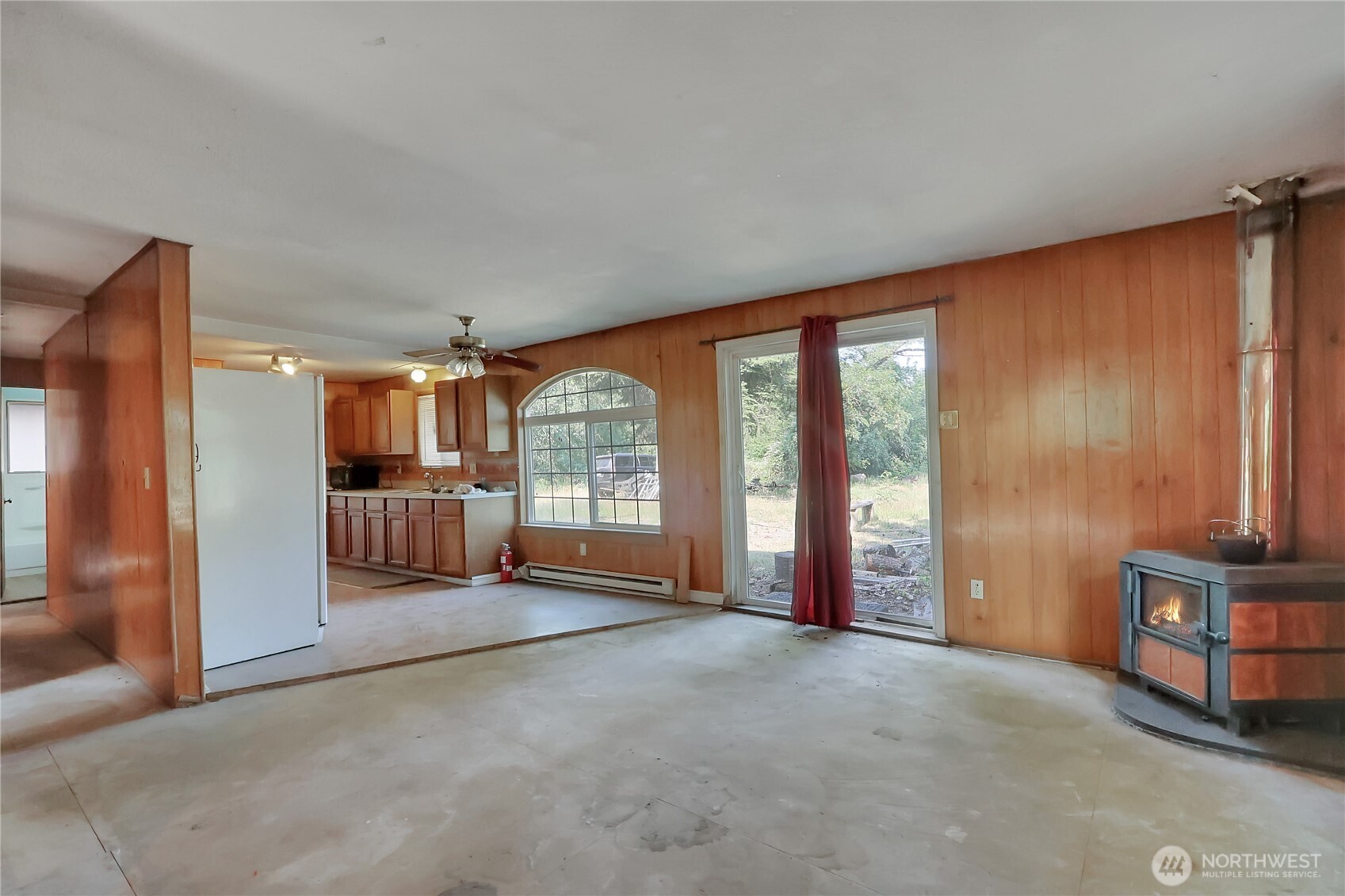 514 Higgins Greig Road South Roy, WA 98580 - Photo 5 of 19 a view of an empty room with a fireplace and a large window