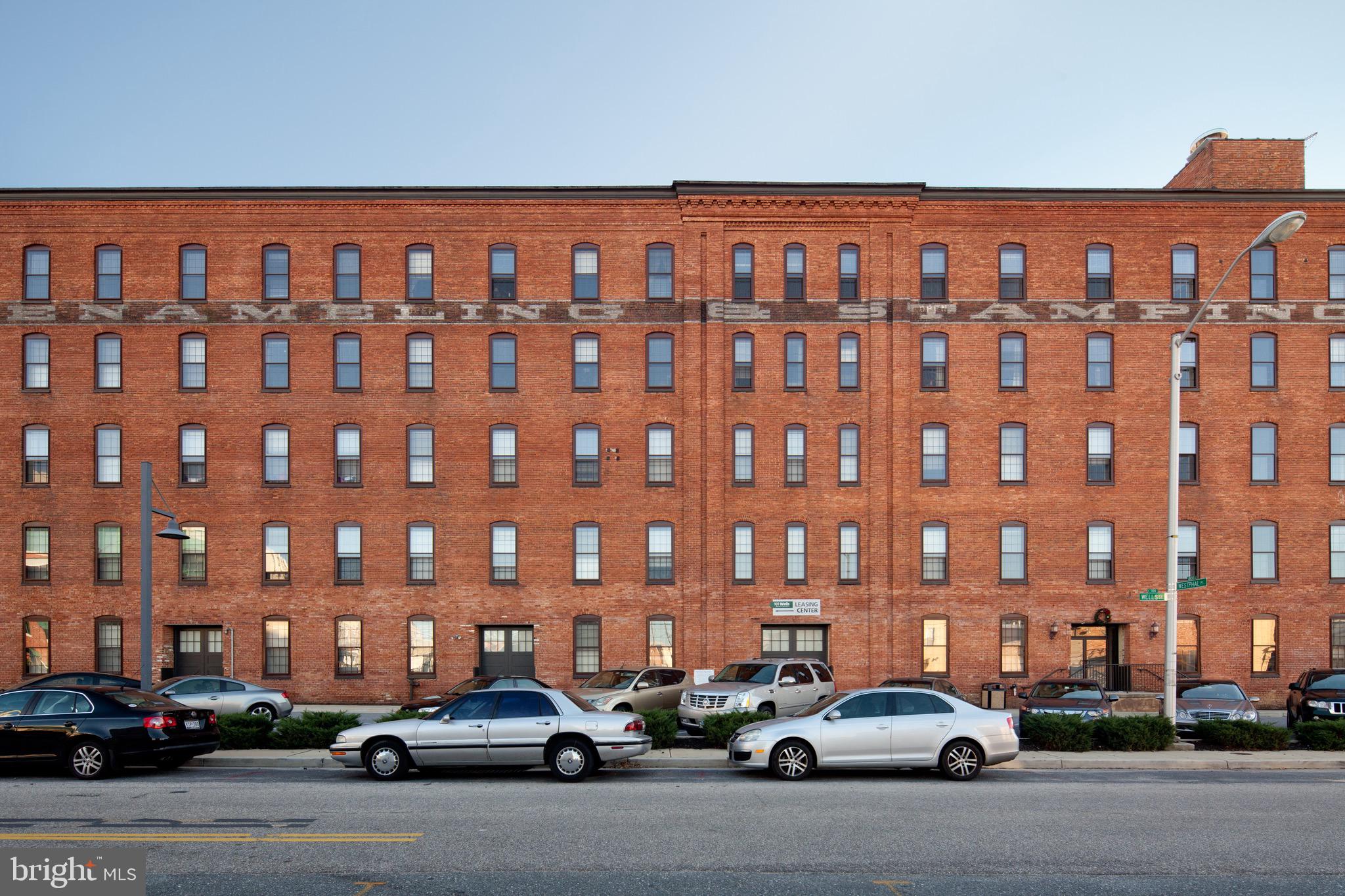 101 Wells Baltimore Md 21230, Unit 1BR Baltimore, MD 21230 - Photo 12 of 46 a city street lined with parked cars and a building