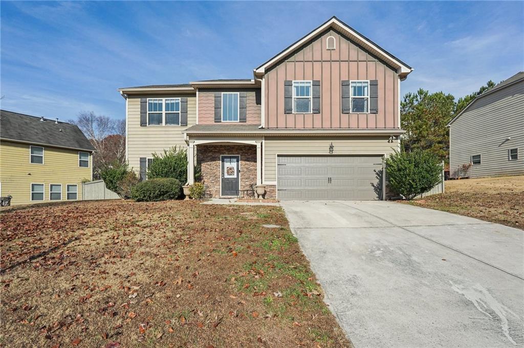 a front view of a house with a yard and garage