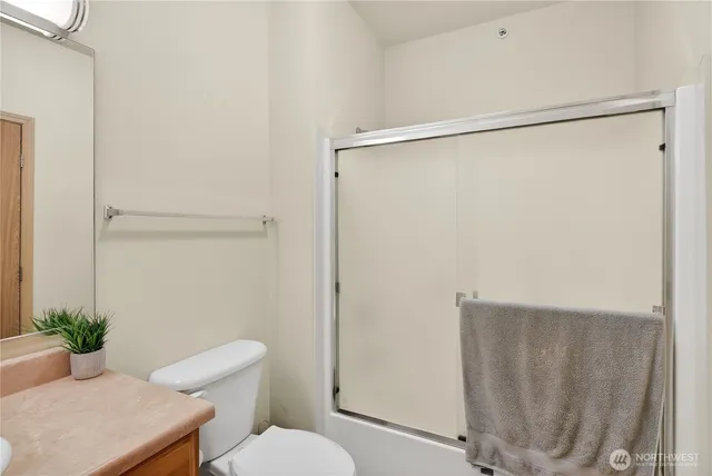 a bathroom with a toilet and a shower