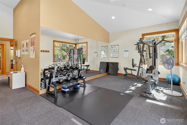 a living room with furniture and large windows