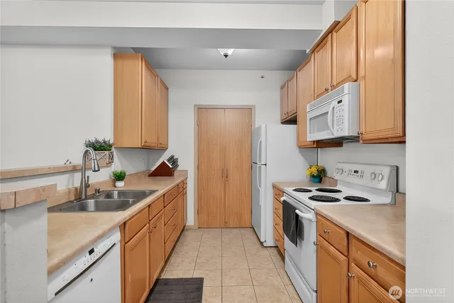 a kitchen with stainless steel appliances a sink stove top oven and cabinets