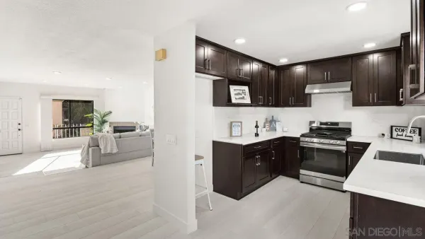 a kitchen with stainless steel appliances kitchen island granite countertop a sink stove and cabinets