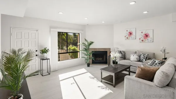 a living room with furniture large window and a fireplace