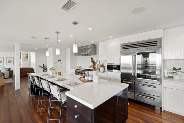 a living room with lots of furniture and a large window