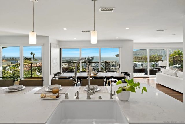 a kitchen with stainless steel appliances a stove a sink a refrigerator and cabinets