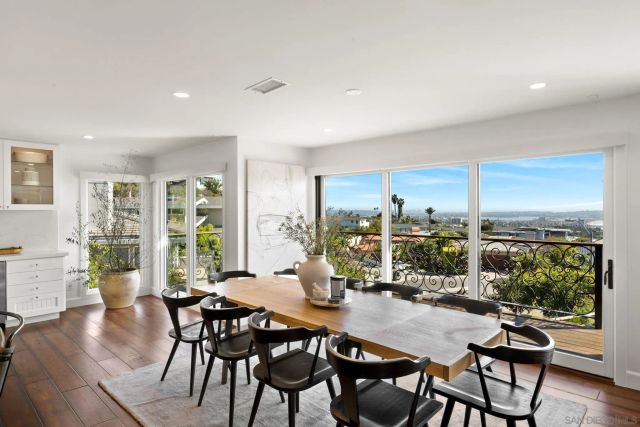 a living room with furniture wooden floor and a large window