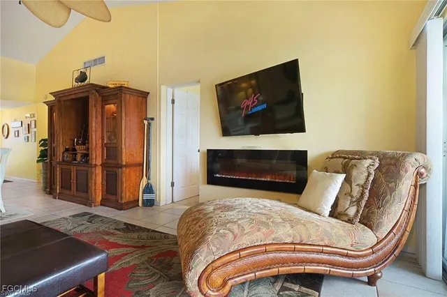 a view of a dining room with furniture clock and a chandelier