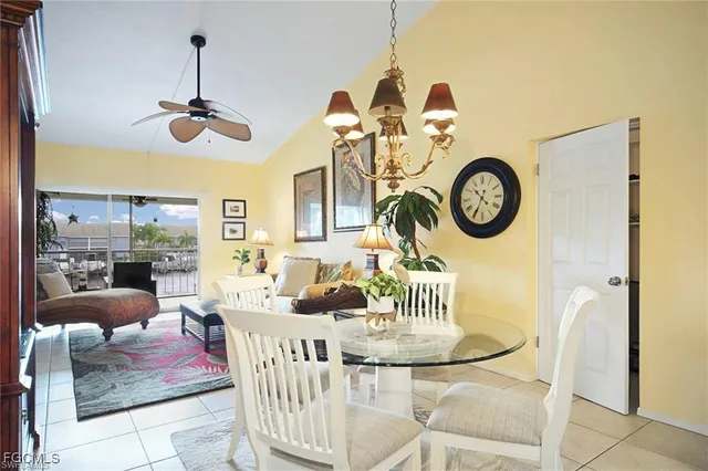 a view of a dining room with furniture and a chandelier