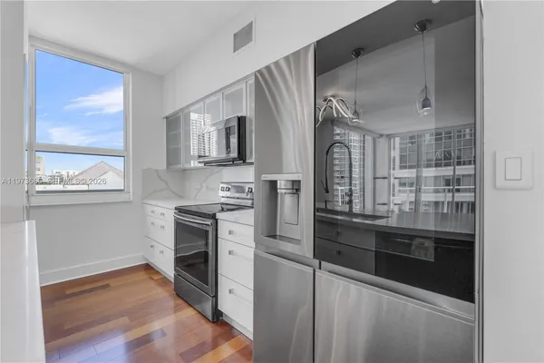 a kitchen with stainless steel appliances granite countertop a stove and a refrigerator